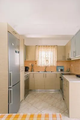 an empty kitchen with a sink and a refrigerator at Sofia's house 2 in Chania Town