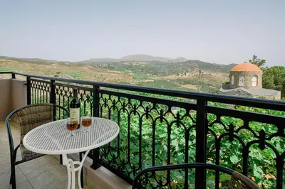 a table with two glasses of wine on a balcony at Sofia's house 2 in Chania Town