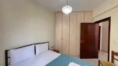 a bedroom with a bed and a wooden door at Angie A2 close to the beach by 8essentially in Chania Town