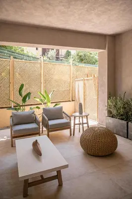 a living room with two chairs and a table at Hestia Boutique Rooms in Agia Marina Nea Kydonias
