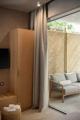 a living room with a couch and a window at Hestia Boutique Rooms in Agia Marina Nea Kydonias