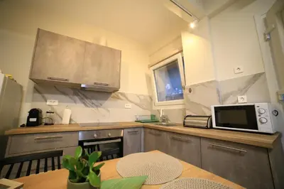 a kitchen with a microwave and a table in it at GREEN n' BLUE apartments in Kalamaki Chanion