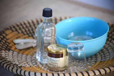 a table with a bottle and a bowl and a container ofredients at GREEN n' BLUE apartments in Kalamaki Chanion
