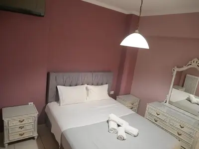 a bedroom with a bed with two towels on it at Gio's Central Cosy Apartment with private balcony in Chania Town