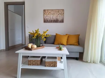 a living room with a couch and a table at Iris&Phaedra in Ayiá