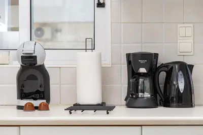 a kitchen counter with a coffee maker and a coffeemaker at Koum Kapi Mare Studios C2 in Chania Town