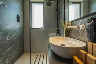 a bathroom with a sink and a glass shower at Nos Aqua Villas Chania in Pazinos