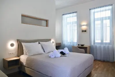a bedroom with a bed with towels on it at Casa Kallisti in Chania Town
