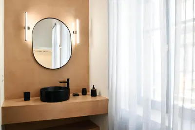 a bathroom with a sink and a mirror at Casa Kallisti in Chania Town