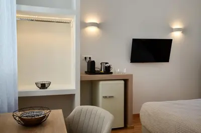 a bedroom with a bed and a television on the wall at Casa Kallisti in Chania Town