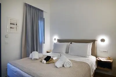 a hotel room with a bed with towels on it at Casa Kâllisti Grande in Chania Town