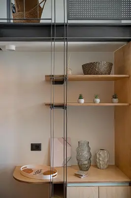 a glass shelving unit with pots and vases on it at Nature's Den in Frangokastello