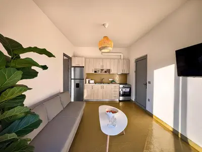 a living room with a couch and a table at Mekia's beach house in Livadia