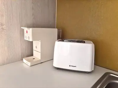 a toaster andrigerator sitting on top of a counter at Mekia's beach house in Livadia