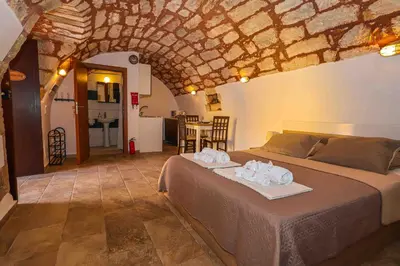 a bedroom with a bed with two towels on it at SternesVillage, Lower Ground Floor in Stérnai