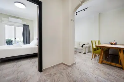 a mirror in a room with a bed and a table at Sophia Apartment in Chania Town