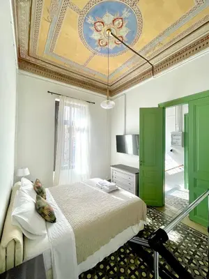 a bedroom with a large bed with a ceiling at La Sistina in Chania Town