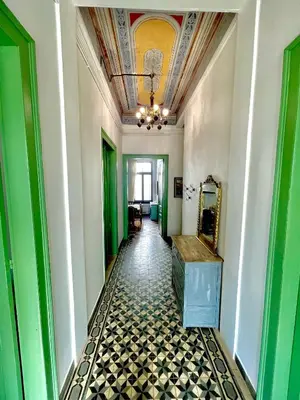 a hallway with green and white walls and a ceiling at La Sistina in Chania Town