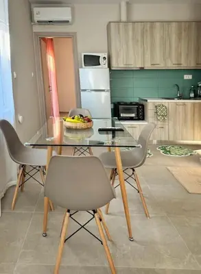 a kitchen with a table and chairs with a bowl of fruit at Christina & Suzan Apartment in Chania Town