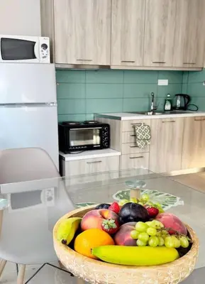 a bowl of fruit on a glass table in a kitchen at Christina & Suzan Apartment in Chania Town