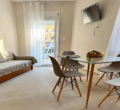 a living room with a table and chairs and a bed at Christina & Suzan Apartment in Chania Town