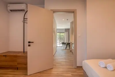a bedroom with a door leading to a dining room at Kiwi Boutique Studios in Kissamos