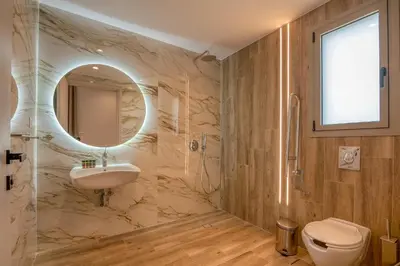 a bathroom with a sink and a mirror at Kiwi Boutique Studios in Kissamos