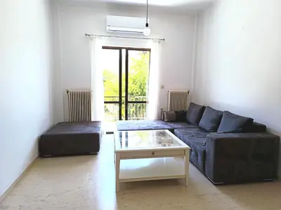 a living room with a couch and a coffee table at Kouklospito in Chania Town