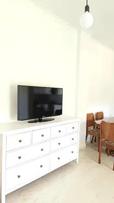 a white dresser with a television on top of it at Kouklospito in Chania Town
