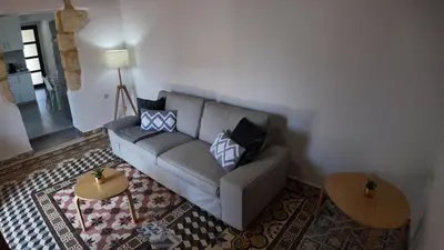 a living room with a couch and a table at Stefanie's House in Chania Town