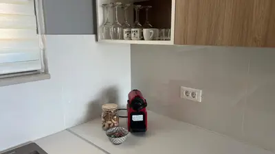 a kitchen counter top with a bottle of wine and a bowl at Fiorella Sea View Pool Villa in Kalyves, Chania area, Crete in Kalyves