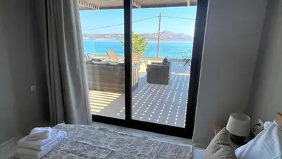 a bedroom with a bed and a view of the ocean at Fiorella Sea View Pool Villa in Kalyves, Chania area, Crete in Kalyves