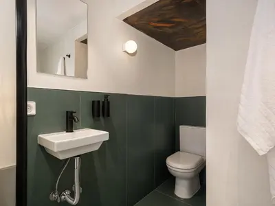 a bathroom with a sink and a toilet at Green Lilly Home in Chania Town