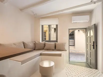 a living room with a couch and a window at Green Lilly Home in Chania Town