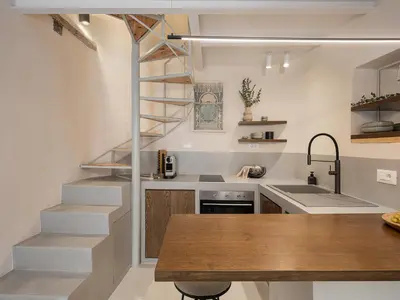 a kitchen with a spiral staircase and a sink at Green Lilly Home in Chania Town