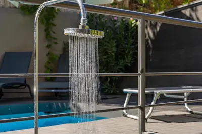 a shower with water coming out of it next to a pool at Blissful Residence with Pool by 8essentially in Daratso