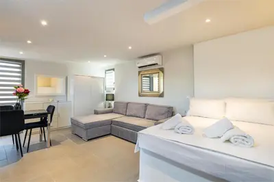 a living room with a bed and a couch at Panorama View Apt with Jacuzzi by 8essentially in Daratso