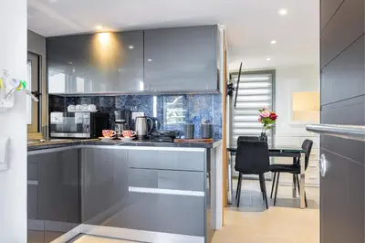 a kitchen with stainless steel appliances and a table at Panorama View Apt with Jacuzzi by 8essentially in Daratso
