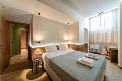 a bedroom with a large bed with towels on it at Kia's city retreat in Chania Town