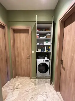 a laundry room with a door and a microwave at Kia's city retreat in Chania Town