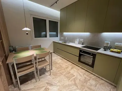 a kitchen with a table and some chairs and a counter at Kia's city retreat in Chania Town