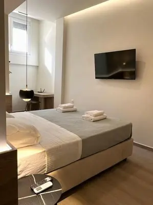 a bedroom with a bed with a television on the wall at Kia's city retreat in Chania Town