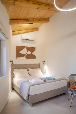 a bedroom with a bed and a wooden ceiling at Comfinest in Chania Town