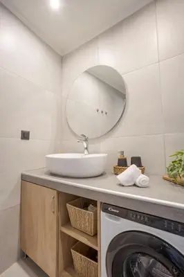 a bathroom with a sink and a washing machine at Comfinest in Chania Town