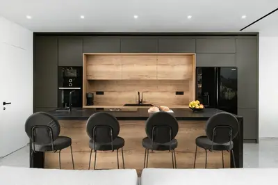 a kitchen with black chairs and a kitchen island at Paradise Hill Luxury Villa in Kalyves