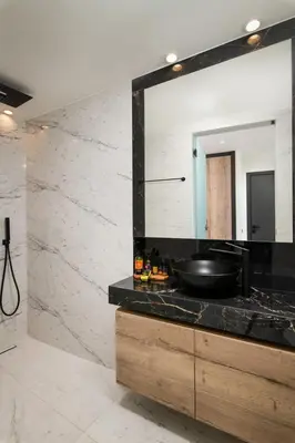 a bathroom with a sink and a mirror at Paradise Hill Luxury Villa in Kalyves