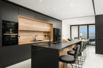 a kitchen with a large island with black counter tops at Paradise Hill Luxury Villa in Kalyves