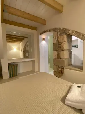 a bedroom with a bed and a stone wall at Teviot, 