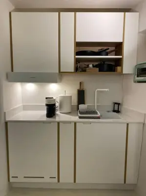 a kitchen with white cabinets and a counter top at Teviot, 