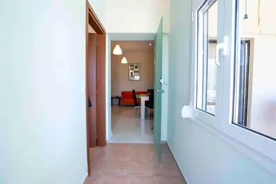 a hallway with a door leading to a dining room at Villa Marianna Lygides in Ayiá